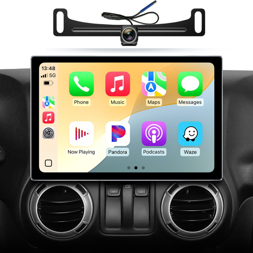 AINAVIGO touchscreen radio with CarPlay apps on screen, set into a Jeep Wrangler dash above the round vents, with a license plate backup camera