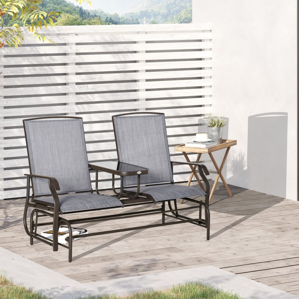 Two-seat Outsunny mesh glider with a small table between the seats on a pale wood deck beside a white slatted fence
