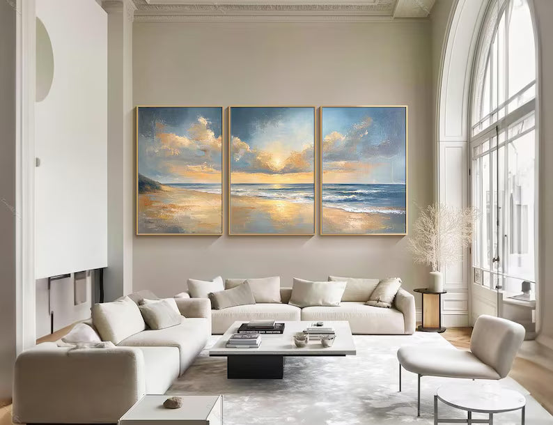 Ocean Sunrise textured painting set of three above a living room sofa, an example of Artextured's multi-panel pieces