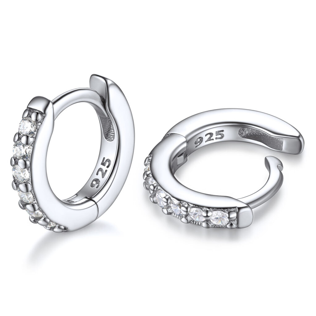 Pair of small silver huggie hoop earrings set with clear stones, with a 925 stamp inside the hoop