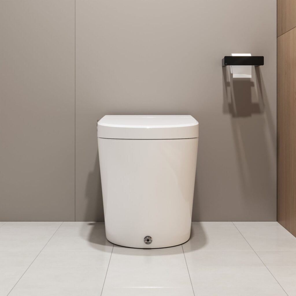 Front view of a white tankless smart toilet with a round foot-sensor button at the base, set against a taupe wall