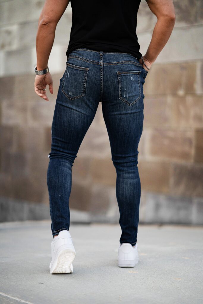 Back view of dark blue skinny jeans showing the back pockets and the slim leg line