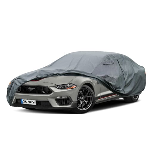 Gray car cover pulled over a coupe with the front section folded back