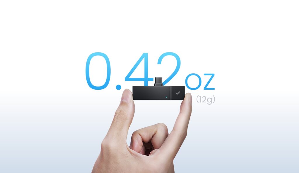 HiDock P1 mini held between two fingers, labeled as weighing 12 grams