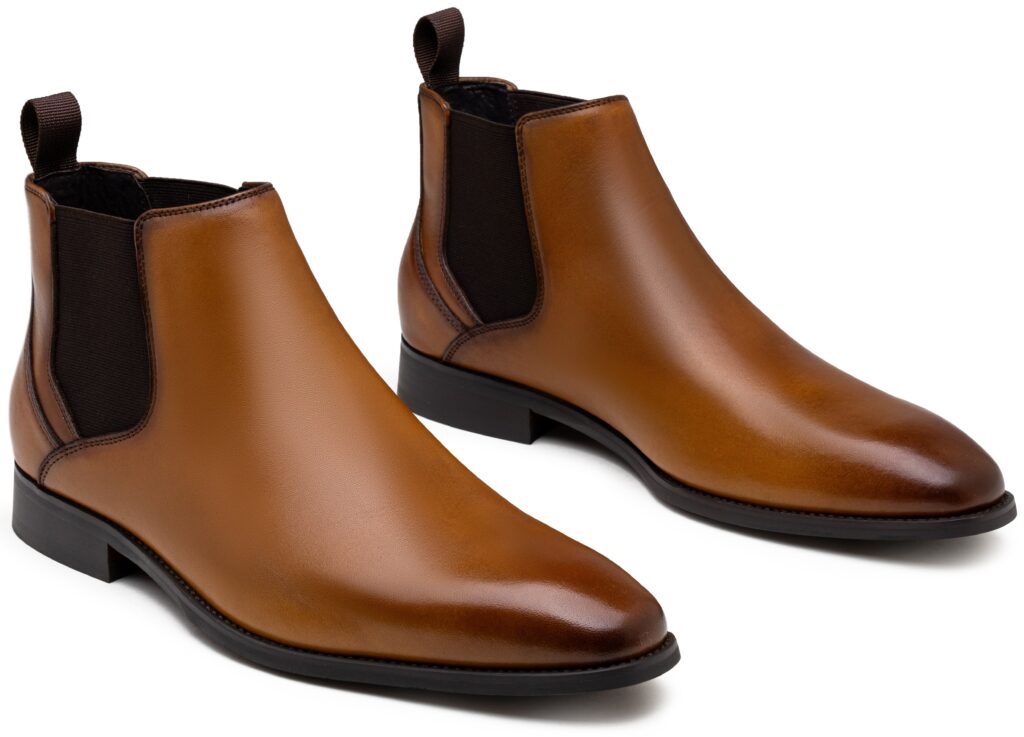 Pair of tan leather Chelsea boots with brown elastic panels, shown from the front and the side