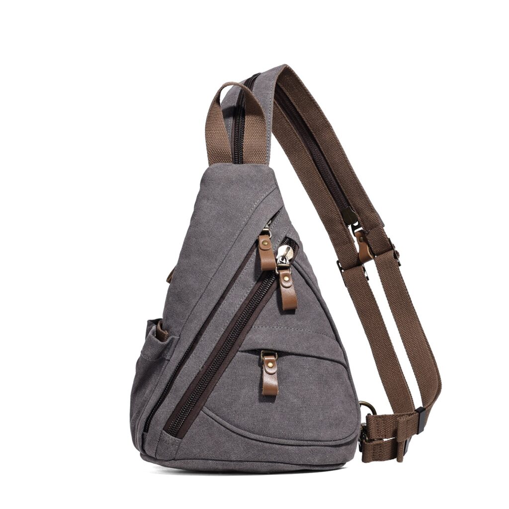 Gray canvas sling bag with a brown strap, side zip pocket and metal clips shown on a white background