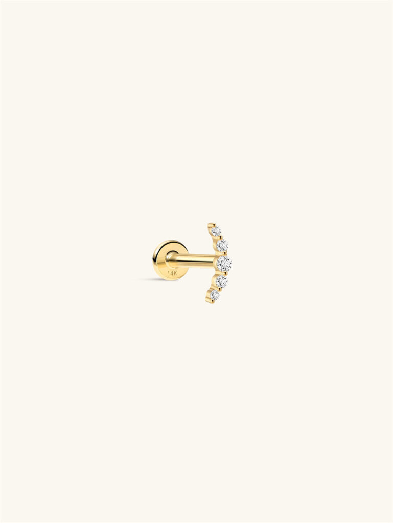 Kosiner 14K gold flat-back stud with a curved row of five small clear stones