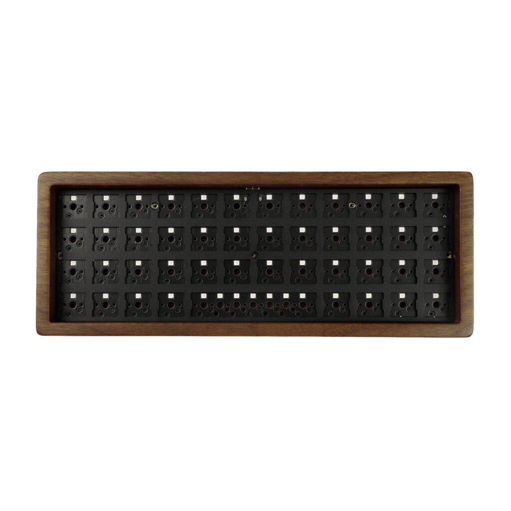 YMDK 40 percent keyboard kit with a wooden case and an empty plate waiting for switches