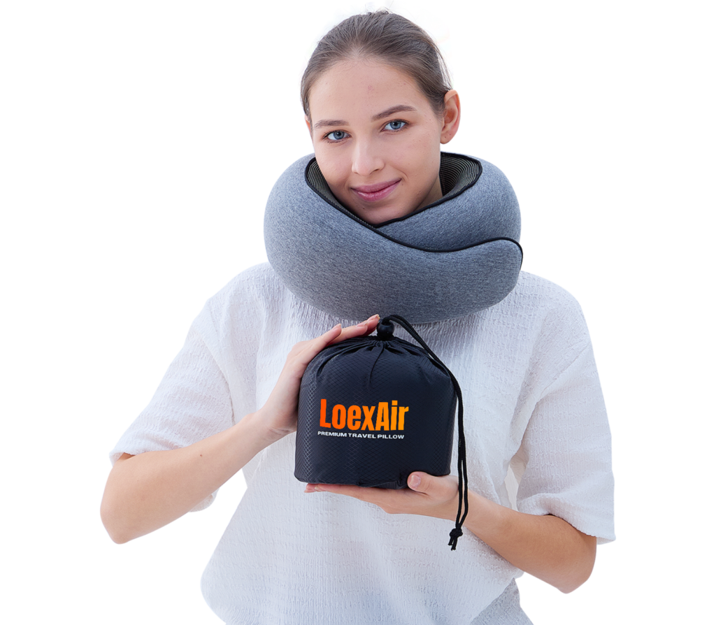 Woman wearing a grey LoexAir neck pillow while holding the black carry pouch