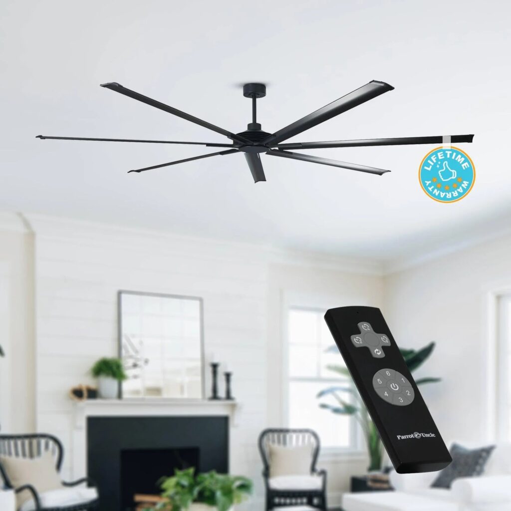 Black Silent Storm ceiling fan above a living room, with its remote control and a lifetime warranty badge