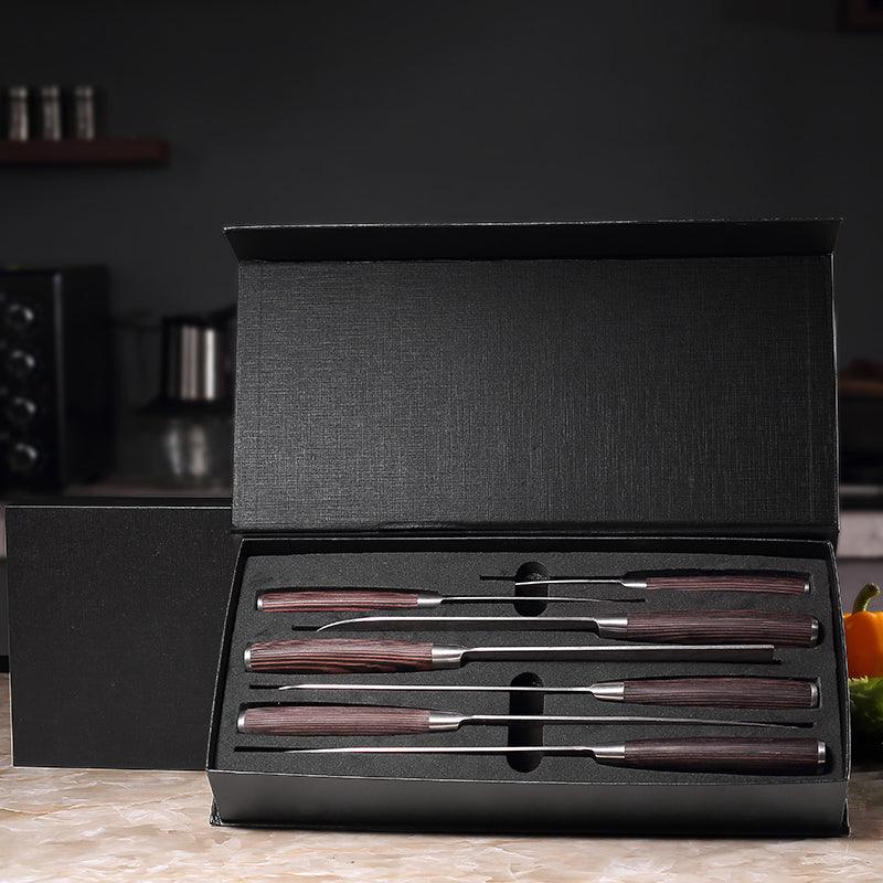 Paudin knives resting in an open black presentation box on a kitchen counter