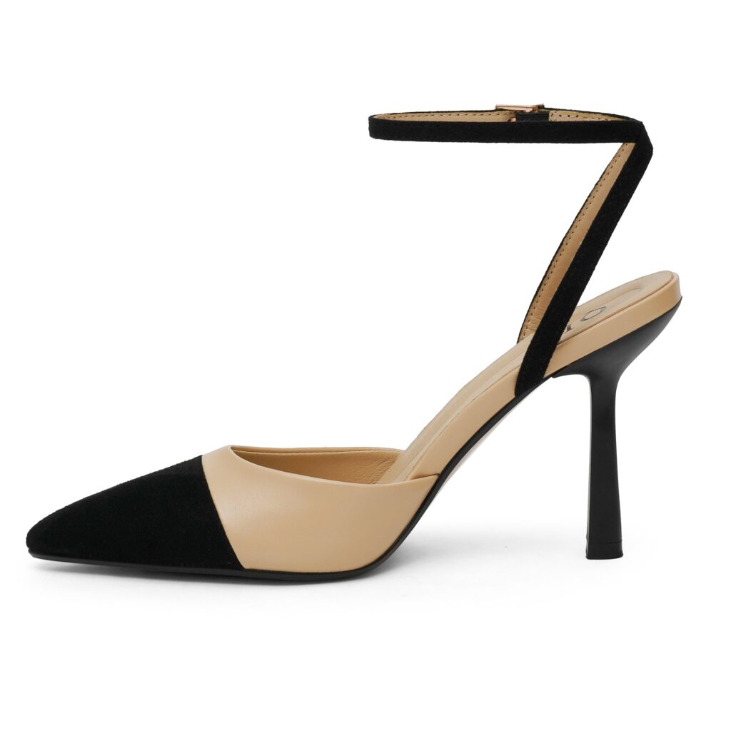 QIY ankle strap stiletto in nude with a black pointed toe cap, shown in side profile to display the slim heel