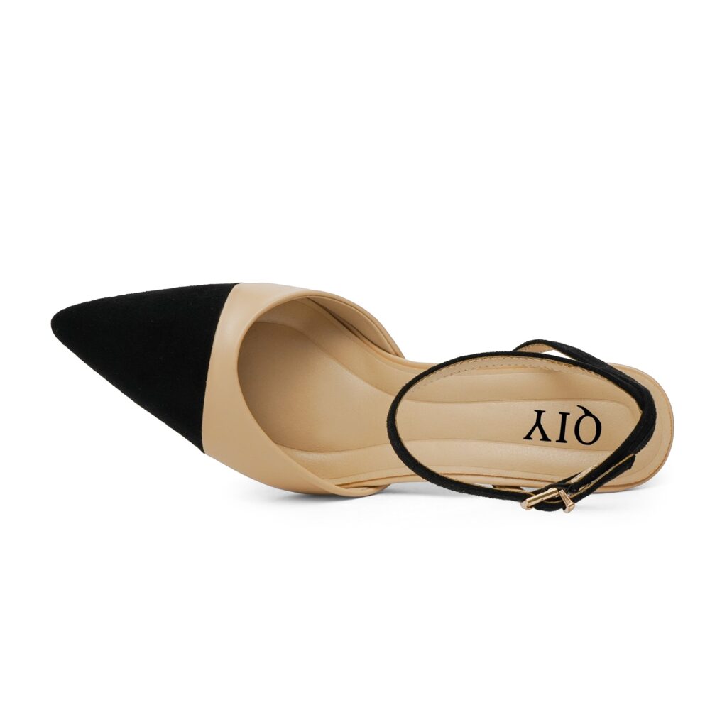 QIY ankle strap stiletto in nude with a black pointed toe cap, seen from above with the buckled strap