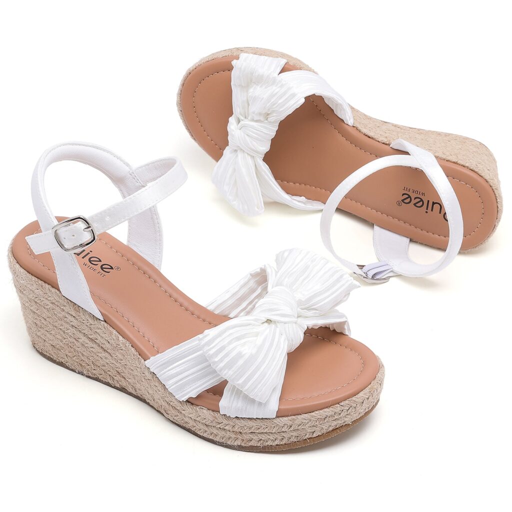 Pair of white bowknot wedge sandals with adjustable ankle straps and woven-look wedge heels