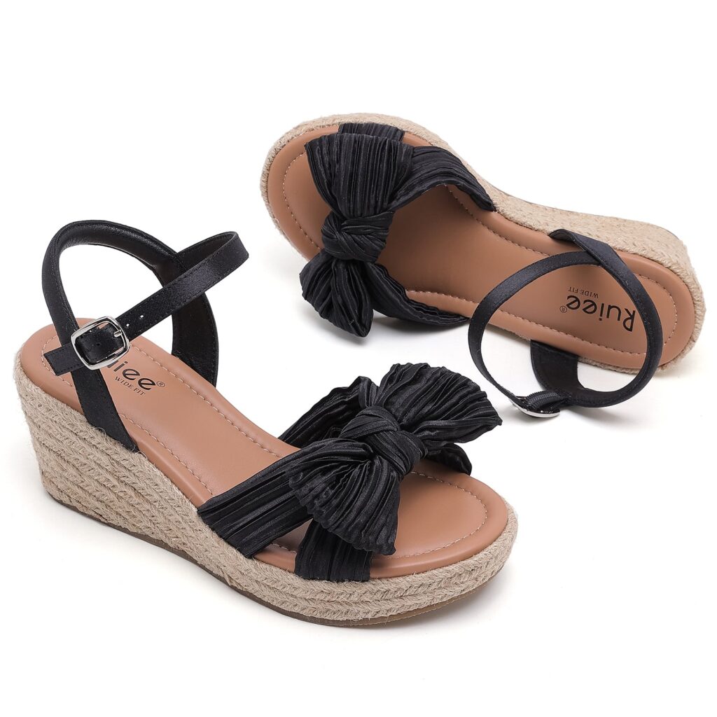 Pair of black bowknot wedge sandals with ankle straps, one shown from above and one from the side