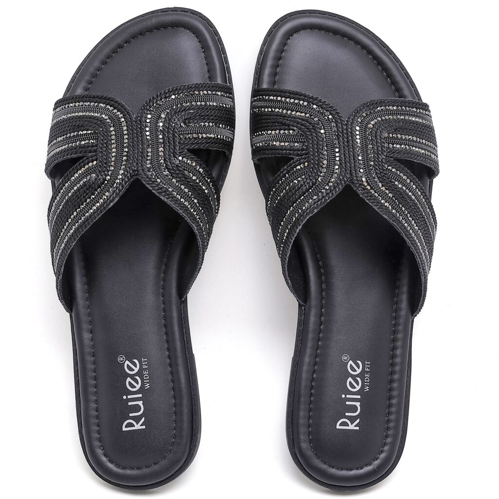Pair of black slide sandals with crisscross embellished straps, shown from above
