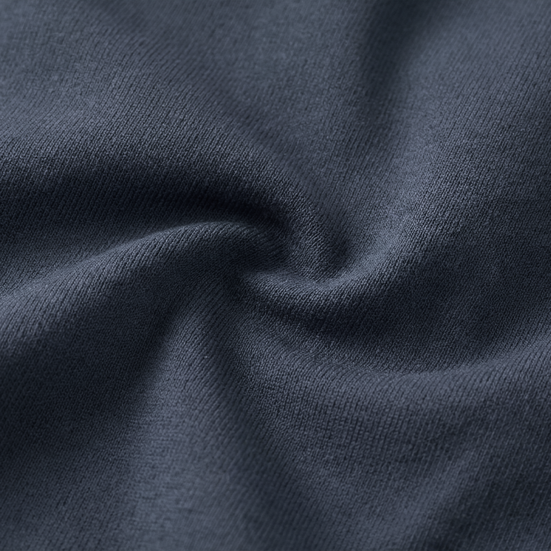 Close-up of soft dark gray stretch fabric gathered in a gentle twist
