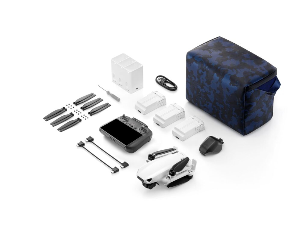 SkyRover S1 combo kit laid out with the drone, touchscreen remote, three batteries, charging hub, spare propellers and a camouflage carrying bag