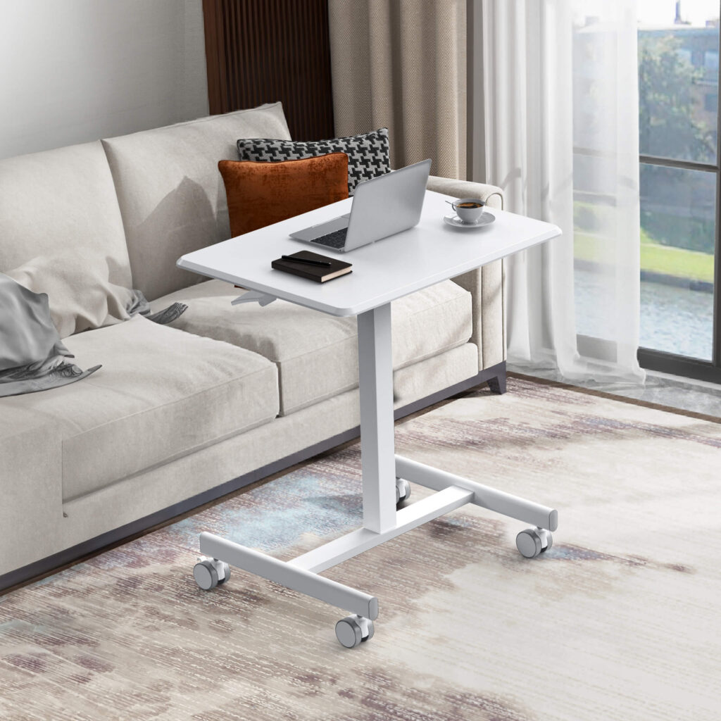 White Sweetcrispy rolling laptop desk parked beside a sofa with a laptop and a cup of coffee on top