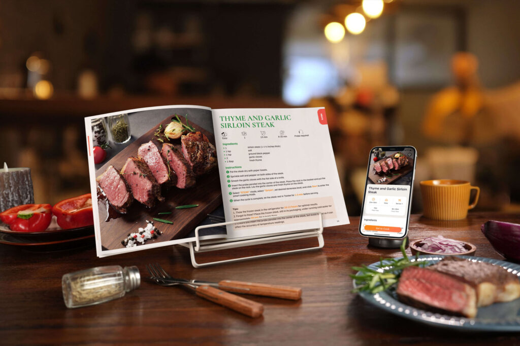 Open Tastee cookbook beside a phone showing the same steak recipe in the Tastee app