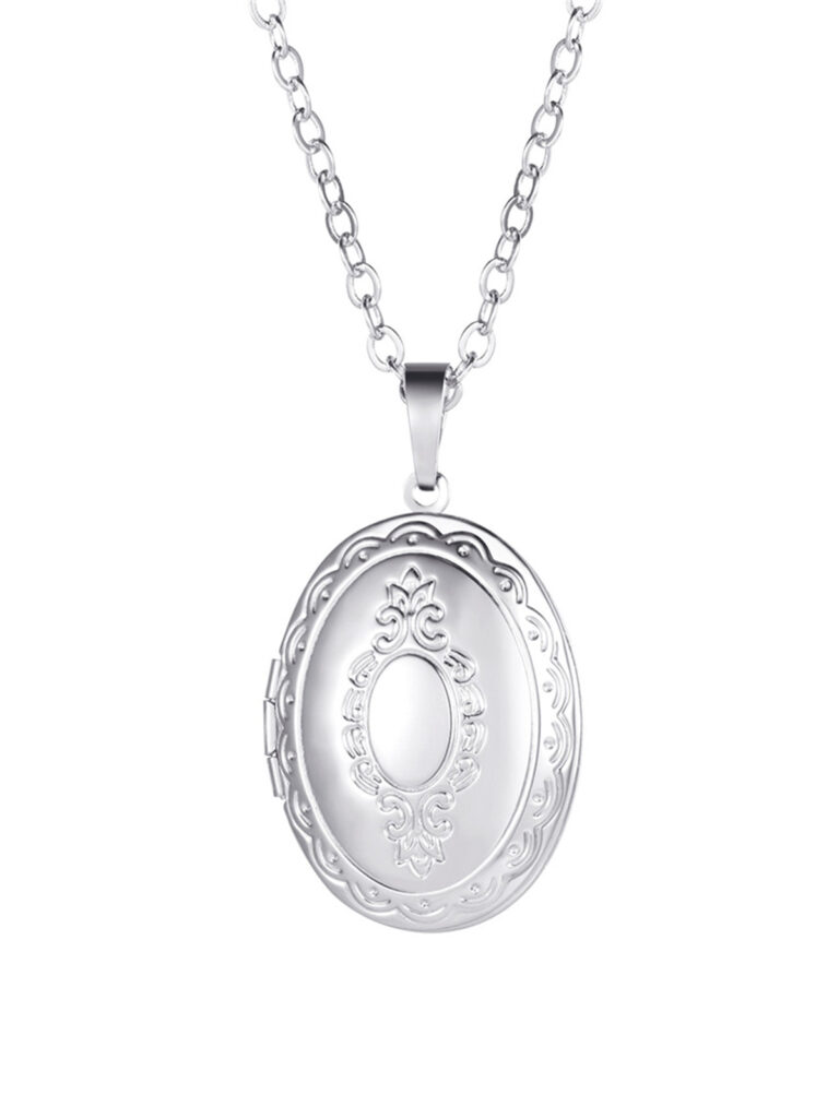 Oval locket on a cable chain with an engraved scalloped border and an ornate frame at the center