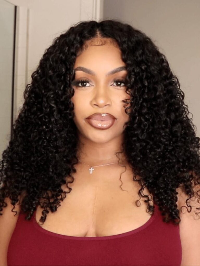 Woman wearing UNice's InvisiBlend V-Part wig in a full, defined jerry curl