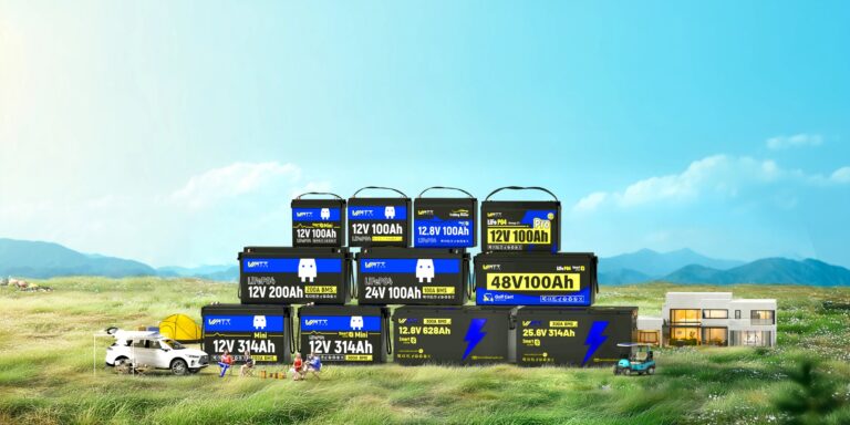 A range of WattCycle LiFePO4 batteries in 12V, 24V and 48V sizes stacked on a grassy field