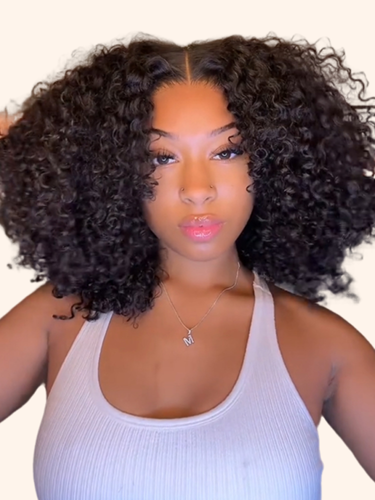 Model with a full, voluminous curly Wiggins Hair wig, an example of a high-density look